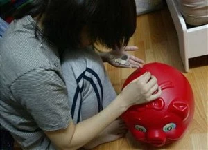 piggy bank Girl puts money into piggy bank